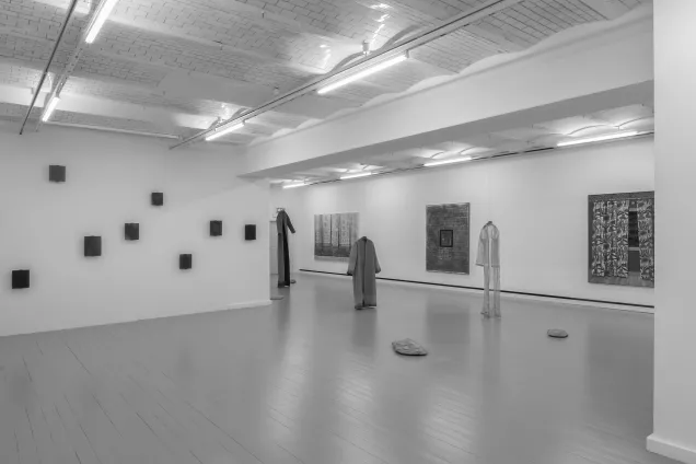 Exhibition in a big white room. Photo. 