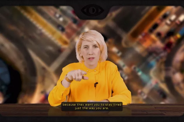 Woman on a tv screen pointing with her finger. Photo.