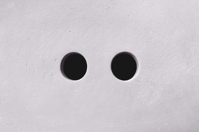 Two holes in a concrete wall. Photo.